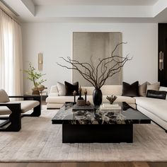 a living room filled with furniture and a painting on the wall above it's coffee table