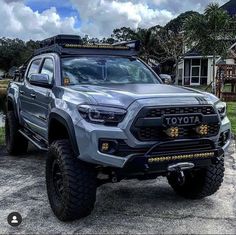 a grey truck parked in front of a house