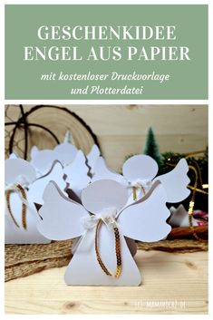 some white angel shaped paper on top of a wooden table