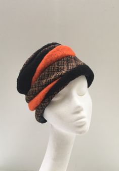 A lined hat made from 100% authentic, genuine Harris Tweed handwoven in the Outer Hebrides, and wool fabric.  Hat designed and hand made by me in the Cotswolds . The design comprises of shards of black/tan Harris Tweed, bright tan and black wool; top piped edge. My unique design.  It fits an average size head (approx 57cm measured around the back of the head and across the top of the ears and eyebrows).   I personally selected the Tweed on a visit to the Outer Hebrides. This is a finished, hand Cossack Hat, Cheltenham Races, Outer Hebrides, Wool Top, Harris Tweed, Wool Hat, Hat Making, Wool Fabric, Black Wool