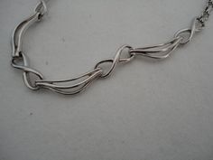 "A highly collectible vintage silver tone panel bracelet by Corocraft. It measures approx 15\" length x 0.25\" width and has a secure ring clasp. Clearly marked hang tag \"Corocraft\" in capital letters preceded by the Pegasus. It is in excellent vintage condition. Postage in the UK is by Royal Mail First Class Signed For service. Postage to all other countries is by Royal Mail Airmail Tracked and Signed For Small Packets service." Handmade Retro Silver Jewelry, Hallmarked Silver Metal Chain Bracelet, Retro Silver Metal Jewelry, Retro Silver Collectible Jewelry, Vintage Sterling Silver Link Jewelry, Retro Silver Jewelry For Anniversary, Silver Retro Jewelry For Anniversary, Vintage Sterling Silver Oval Link Bracelet, Formal Hallmarked Metal Chain Bracelet