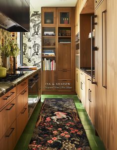 a kitchen with wooden cabinets and an area rug on the floor in front of it