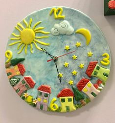 a colorful clock with the sun and stars on it's face is hanging on a wall