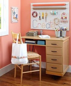 a wooden desk with a white bag on top of it next to a wall mounted pegboard