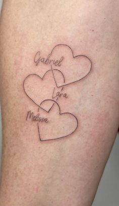 a couple of hearts that are on the back of a woman's leg with words written