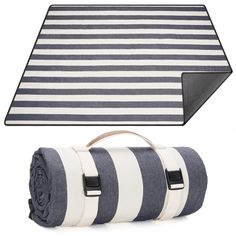 a black and white striped blanket next to a bag