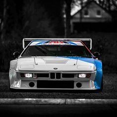 a white and blue car parked on the street