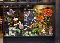 a store front window with flowers in it