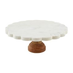 a white marble cake stand with wooden base on an isolated white background for use as a dessert or appetizer