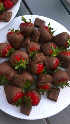 chocolate covered strawberries are arranged on two plates