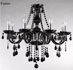 a black chandelier with crystal drops hanging from it's center and sides