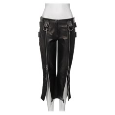 ▪ Dolce & Gabbana Black Leather Capri Pants ▪ Spring-Summer 2000 ▪ The centre-front of each leg features two metal zips allowing for multiple styling options ▪ Belt loops are adorned with large D-rings ▪ Metal zip closures are positioned at the side calf and hips ▪ Designed with a low rise and a slim fit ▪ Size: IT40 - FR36 - UK8 - US4 ▪ Fabric: 100% Leather The photographs presented in this listing, with the exception of any reference or runway imagery, require proper credit to be attributed to Classic Style Aesthetic, Leather Capri Pants, Jack Core, Amy Taylor, Shield Armor, Avantgarde Fashion, Grunge Pants, Rockstar Girlfriend, Low Rise Pants