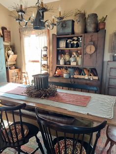 an old fashioned dining room table with chairs