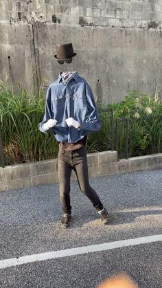 a man walking down the street with a hat on his head