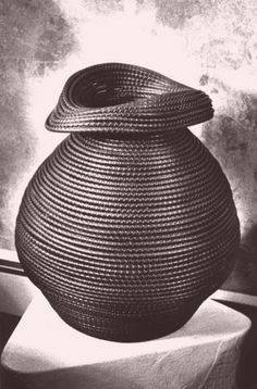 a black and white photo of a large vase