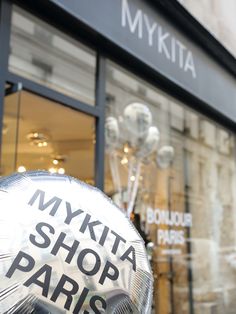 an inflatable object that says, mykita shop paris is on the sidewalk