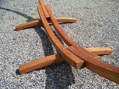 a wooden bench sitting on top of gravel