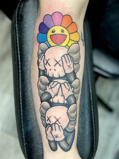 a person with a tattoo on their arm holding a clock and balloons in the shape of a sun