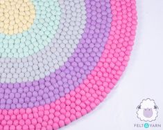 a multicolored round rug made out of cotton balls