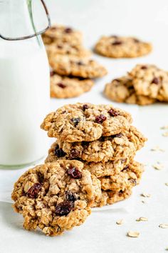 oatmeal raisin chocolate chip cookies stacked next to a glass of milk