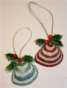 two christmas ornaments with holly leaves and red white and blue beaded decorations on them