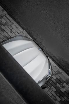 an overhead view of a car parked on the side of a road next to a sidewalk