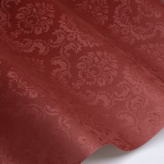 a red fabric with an intricate design on the top and bottom part of it's surface