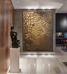 a large metal wall sculpture in the middle of a room with marble floors and walls