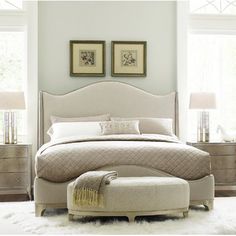 a large bed sitting in a bedroom on top of a white rug