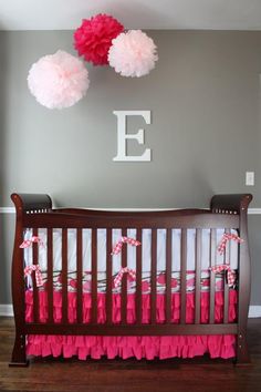 a baby crib with pink and white decorations