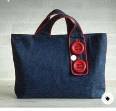 a blue bag with two red buttons on it