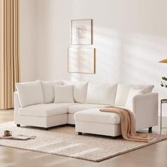 a living room with a white sectional couch