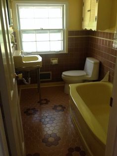 a bath room with a toilet a sink and a bath tub next to a window