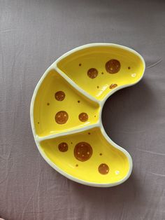 a yellow plate with holes in it on a table