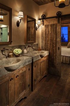 a rustic bathroom with double sinks and wooden cabinets