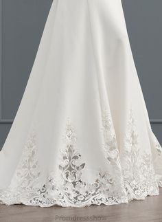 the back of a wedding dress with an open neckline and lace detailing on it