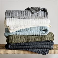 folded blankets stacked on top of each other