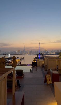 an outdoor restaurant overlooking the water at dusk