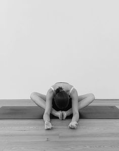 a woman is doing yoga on the floor