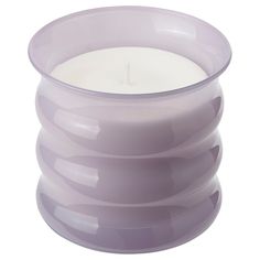 a purple glass candle holder with a white candle in it