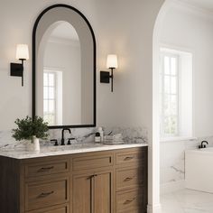 a bathroom with marble counter tops and wooden cabinets, along with two mirrors on the wall