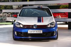 the front end of a blue and white volkswagen golf gti