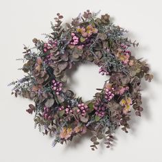 a wreath with purple flowers and green leaves