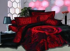 a bed room with a neatly made bed covered in red and black bedspreads