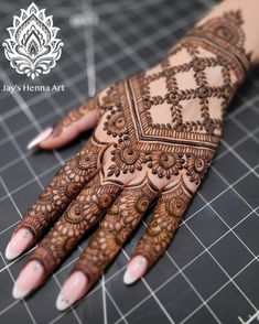 the hands and arms of a woman with henna tattoos