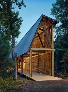 a large wooden structure sitting in the middle of a forest