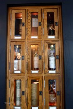 several bottles of liquor in wooden cases on display