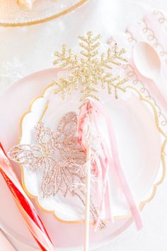 a plate with some candy on it and a snowflake shaped lollipop