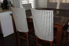 a dining room table with four chairs around it