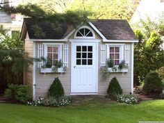 a small house with white trim and windows